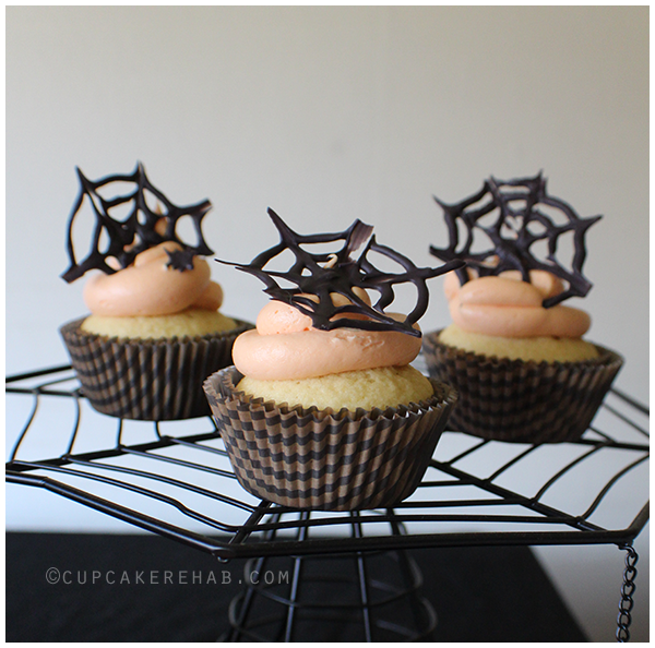 Spiderwebs made from Candy Melts on top of cupcakes!