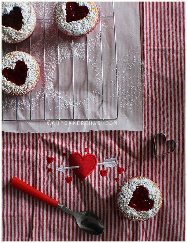 Linzer tart cupcakes! A lemon-vanilla cake filled with strawberry jam.